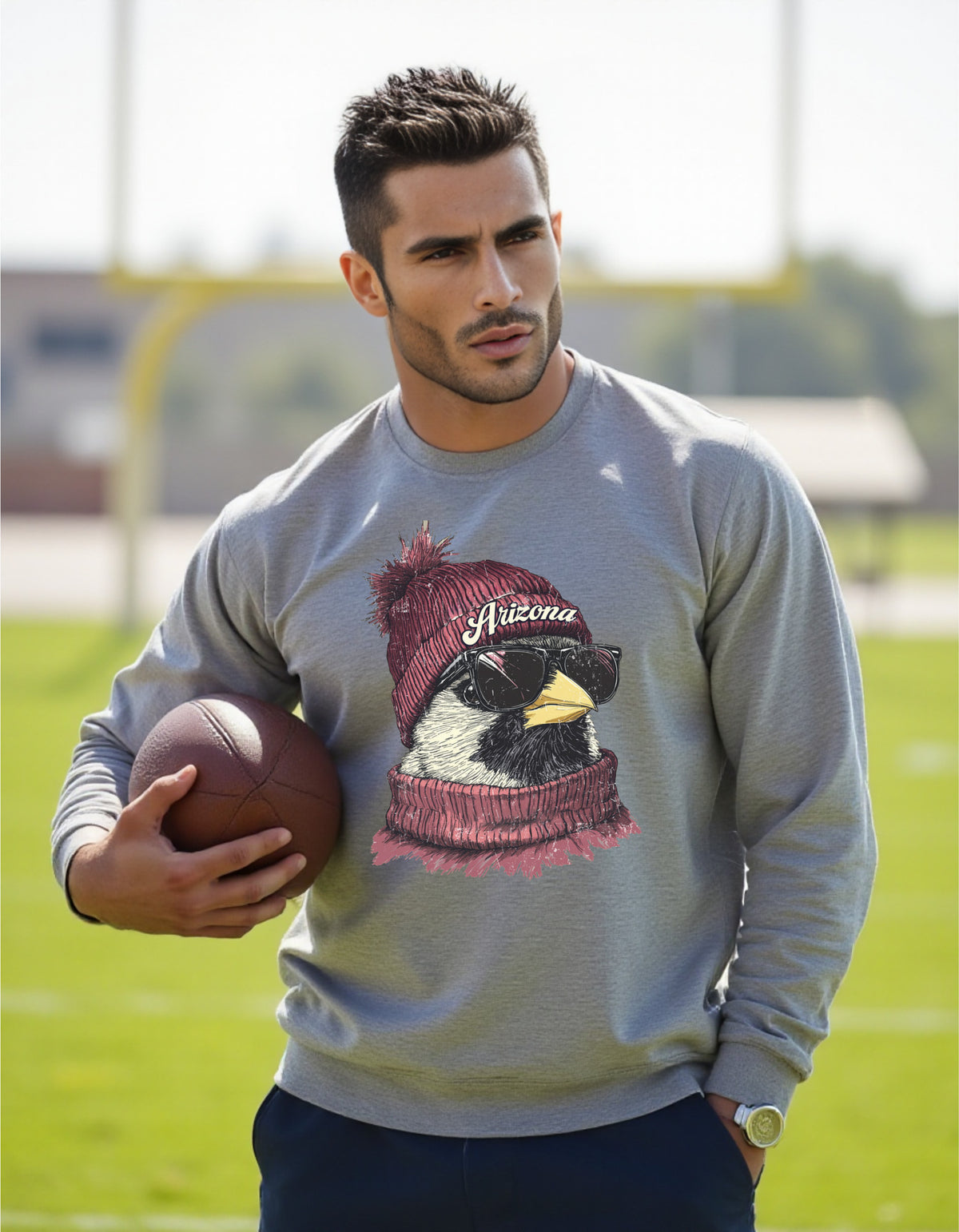 Arizona Cardinals Spirit Animal crewneck sweatshirt on a male model holding a football