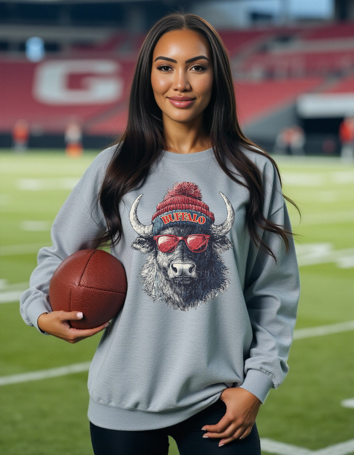 Buffalo Bills Spirit Animal crewneck sweatshirt on a female model holding a football