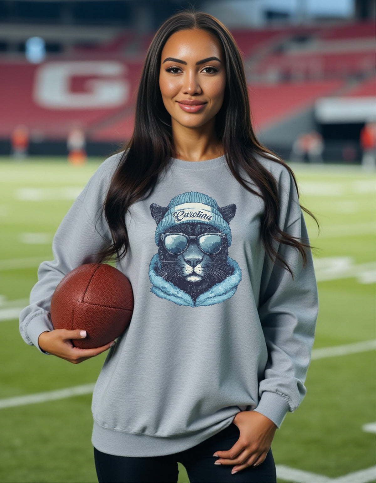 Carolina Panthers Spirit Animal crewneck sweatshirt on a female model holding a football