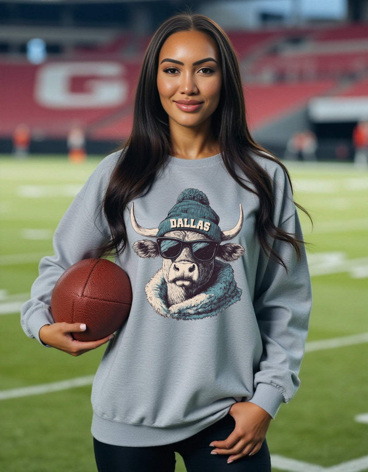 Dallas design 1 – Longhorn Spirit Animal crewneck sweatshirt modeled by a woman holding a football