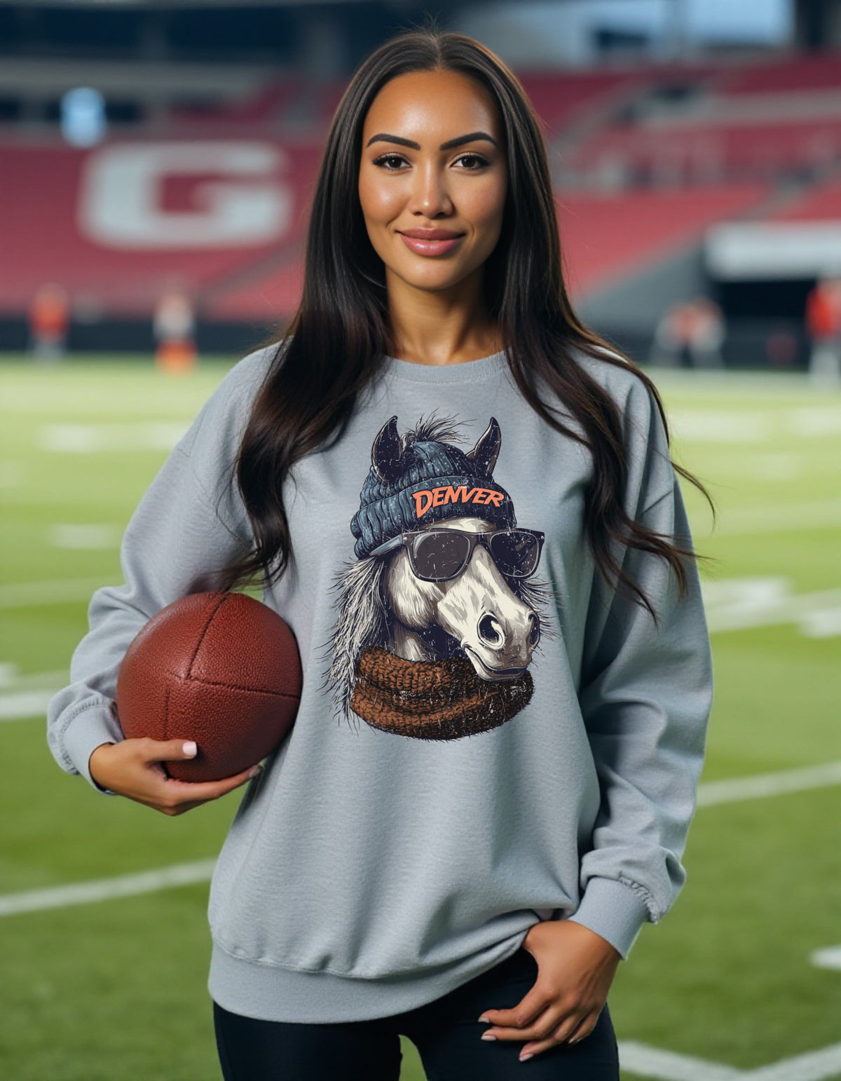Denver Broncos Spirit Animal sweatshirt on female model with football