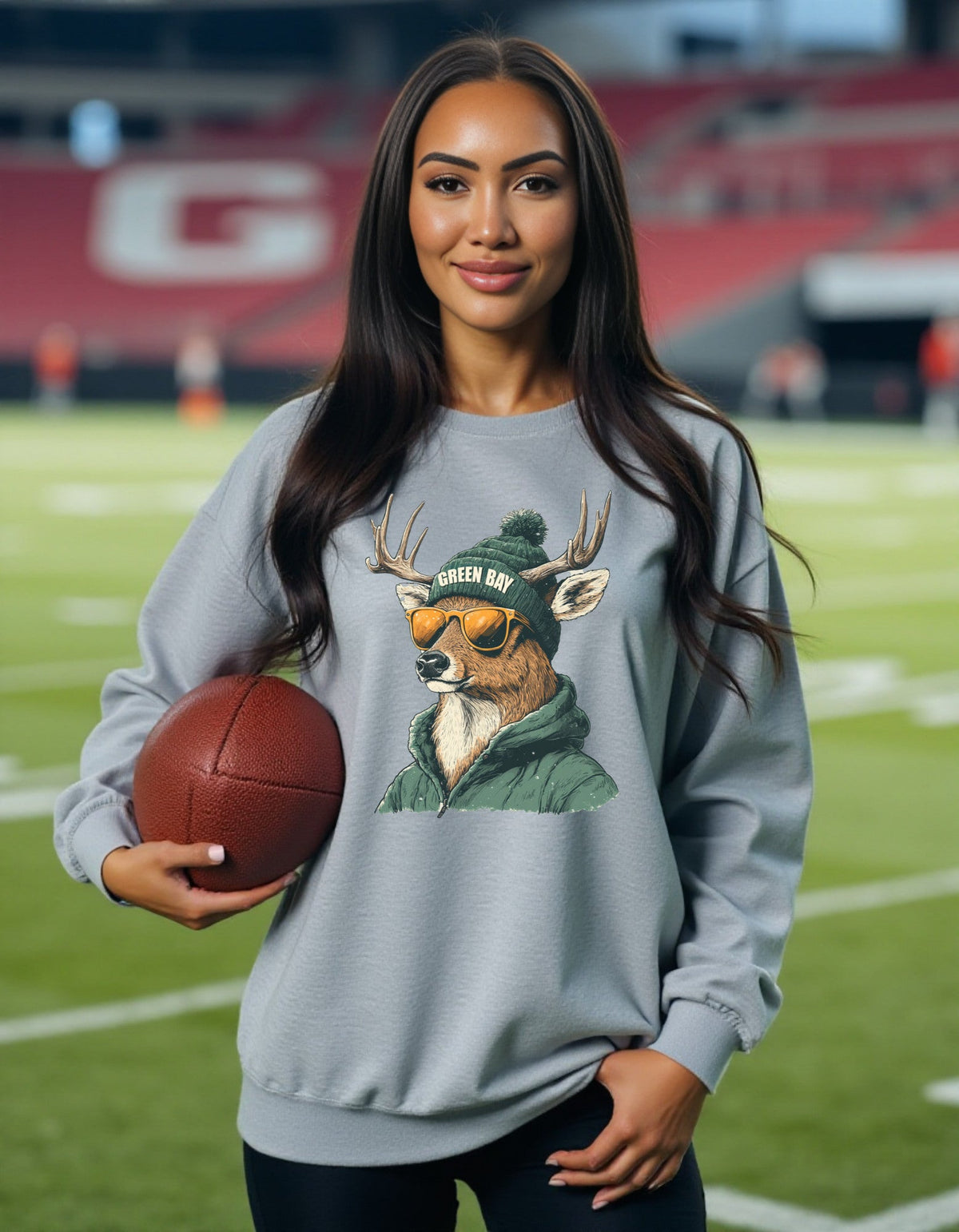 Green Bay Packers Spirit Animal sweatshirt, packers deer artwork, modeled by woman holding a football