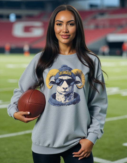 Los Angeles Rams Spirit Animal sweatshirt on female model with football