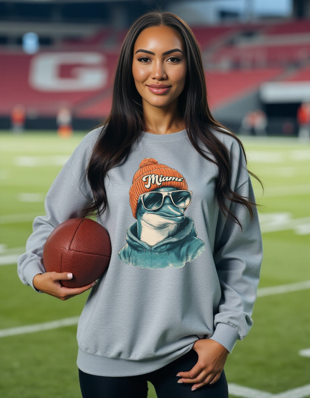 Miami Dolphins Spirit Animal sweatshirt on female model with football