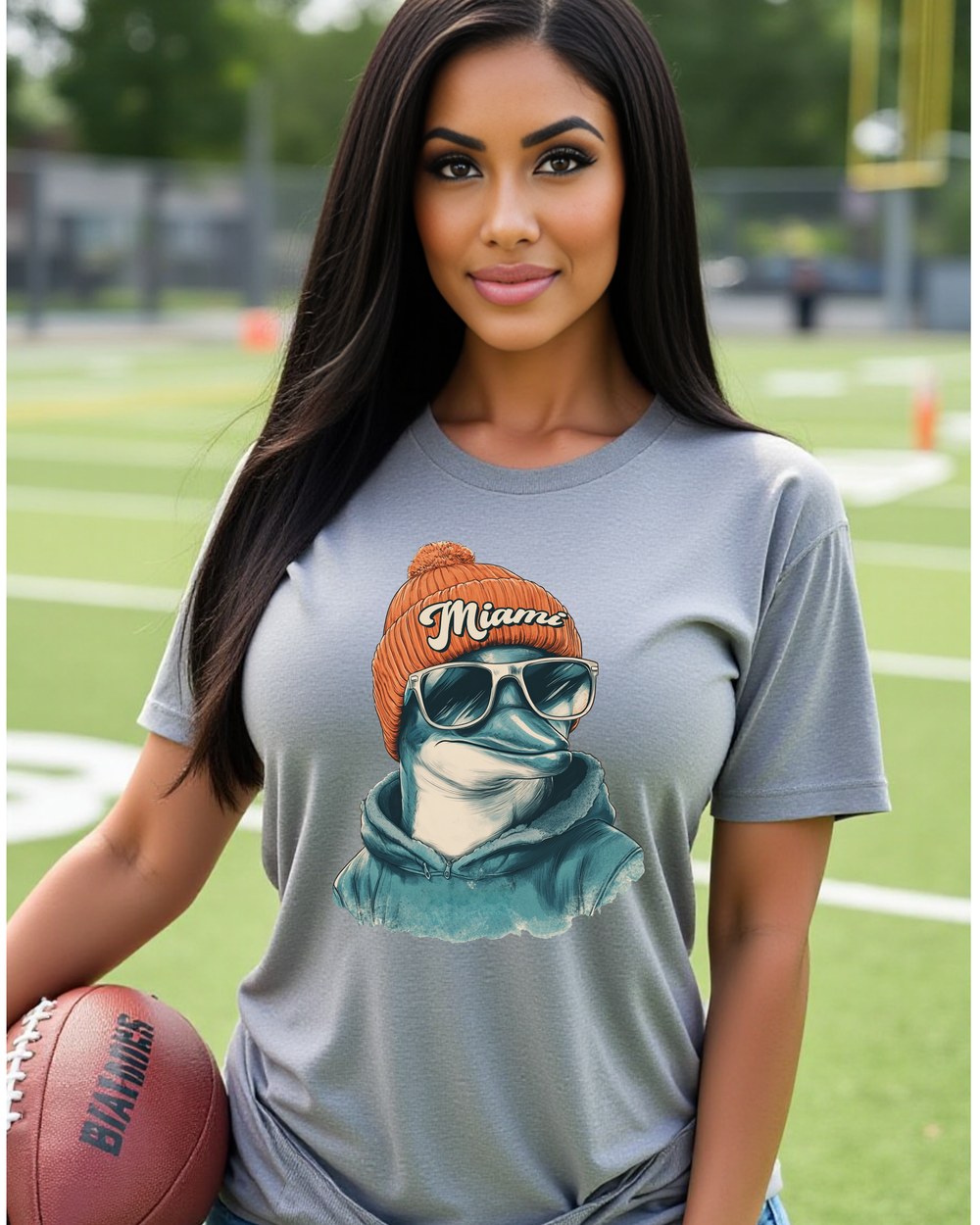 Miami Dolphins Spirit Animal T-shirt shown on female model with football